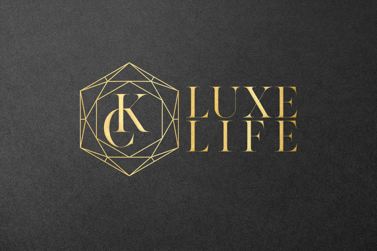 KC Luxe Life, gold emblem with textured black background.